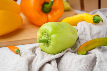 Different fresh peppers on white background