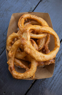 fried onion rings in a compostable container