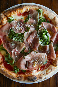 Close up of a Prosciutto and arugula pizza