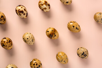 Fresh quail eggs on beige background