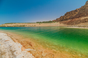 Stunning view panorama of the Dead Sea depicting the unique salt formations along the shore in Jordan's serene landscape in Jordan
