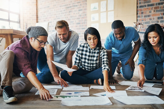 People, creative and work in office with paperwork, collaboration and research for results. Nonprofit campaign, team and ngo in workplace with donation and fundraising growth for volunteer or charity