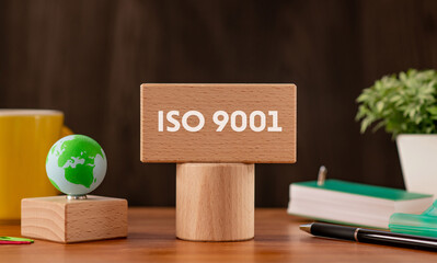 There is wood block with the word ISO 9001. It is as an eye-catching image.