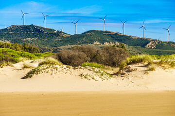 Sand dune and wind turbines on hill, Andalusia Spain © anetlanda