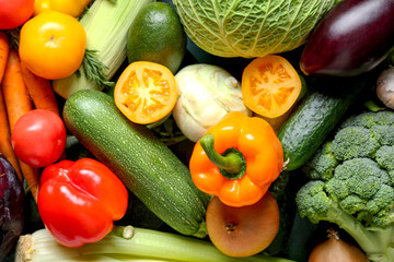 Different fresh vegetables on green background, closeup
