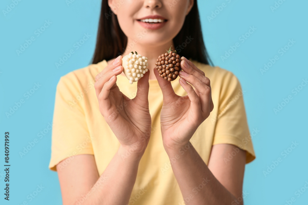 Sticker young woman with chocolate covered strawberries on blue background