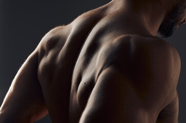 Closeup, muscle and back of man for exercise with workout, gym aesthetic and results for fitness...
