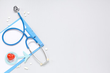 Stethoscope, clipboard, heart and male sign on grey background. Prostate cancer awareness