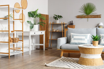 Interior of living room with sofa, shelf units and folding screen