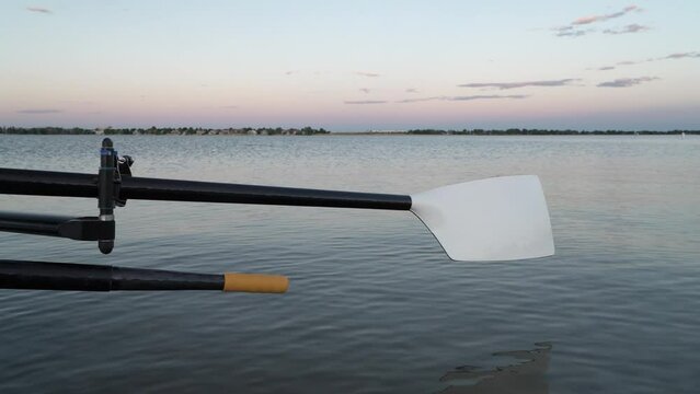 hatchet oars of a rowing shell at dusk on a shore of Boyd Lake, Colorado
