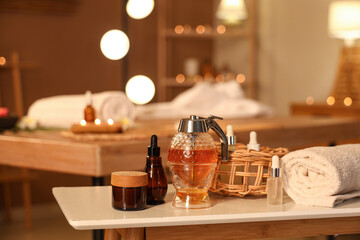 Spa composition with honey on table in spa salon, closeup