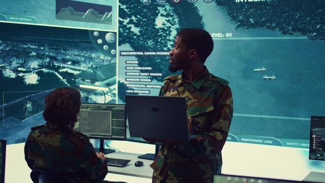 National guard machinist managing cybersecurity measures to protect federal government data from enemy breaches. Army troop conducting reconnaissance or demining operations. Camera B.