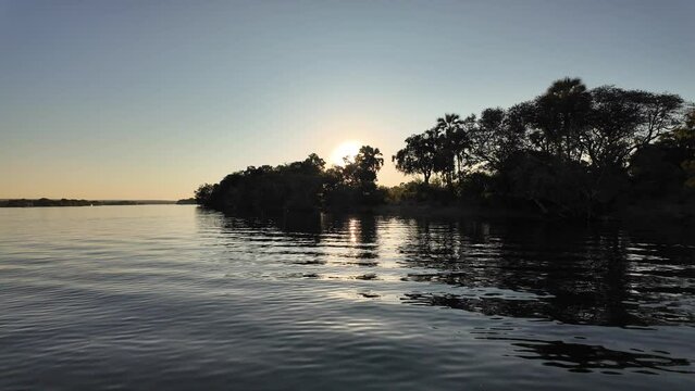 Sunset Forest At Zambezi River In Victoria Falls Zimbabwe. Colorful Sunset. Nature Landscape. Zambezi River At Victoria Falls Zimbabwe. Cruise Safari Background. Travel Scenery.