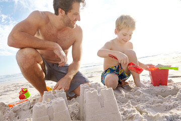 Father, son or building with sand castle and smile on beach for vacation, sunshine in nature. Male...