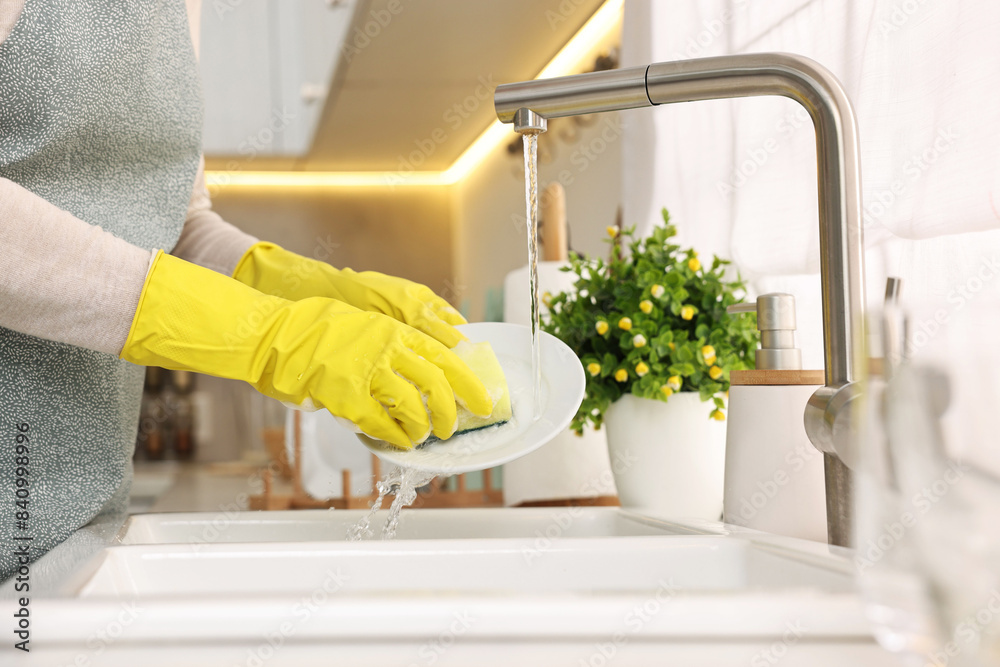 Canvas Prints Housewife washing plate in kitchen sink, closeup