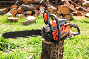 One modern saw on wooden log on sunny day