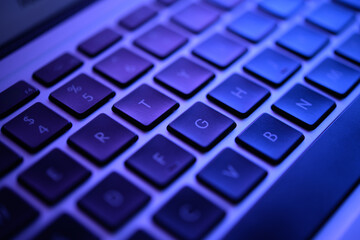 Close-Up Shot of a Glowing Blue Keyboard under Low Light, Detailing Keys R, T, Y and Others