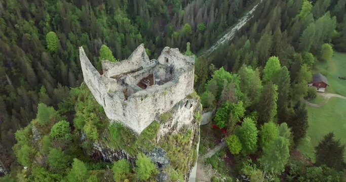 Aerial view of Castel Pietra in the Dolomite Alps of Italy. the ruins of the castle on top fueled the beautiful landscape of nature. High quality 4k footage