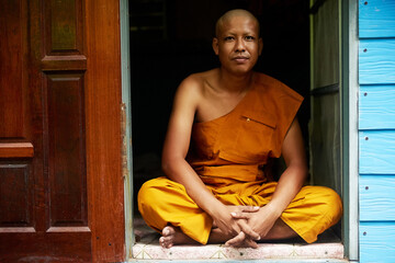 Monk, portrait and meditation in house for culture, zen and spirituality in traditional home. Man,...