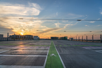 Fototapeta premium Empty rooftop carpark at sunset 