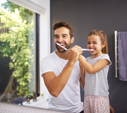 Home, brushing teeth and father with girl, cleaning mouth and morning routine with hygiene. Family, dad and daughter with fresh breath, grooming or oral care with dental wellness, healthy or bathroom