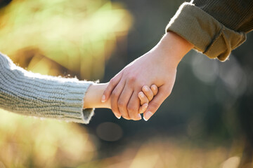 Holding hands, love or mother and child at park for travel, bonding and support in nature together...