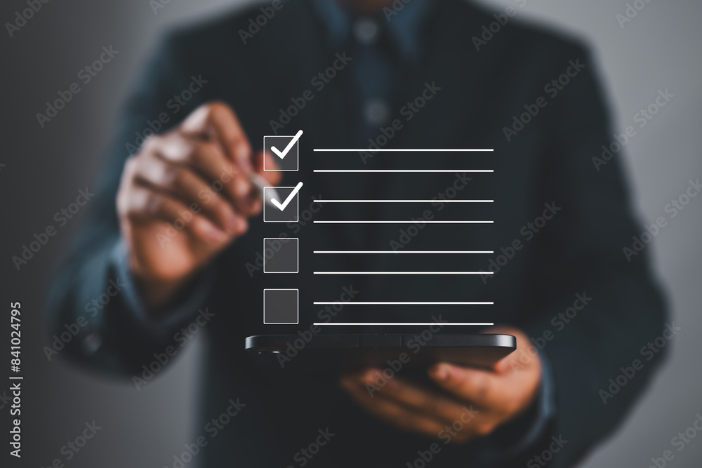 Fototapete Checklist concept. Person use smartphone to checking mark on checkboxes for business performance monitoring and evaluation.