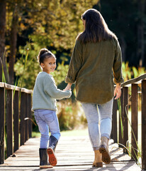 Portrait, young girl and mother hand holding on walk outdoor in park for bonding, relationship and...