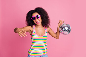 Photo of adorable woman with perming coiffure dressed knit tank in sunglass hold disco ball dancing...