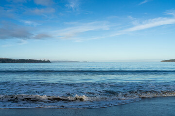 beautiful waves rolling in on a sandy beach in winter in Tasmania Australia
