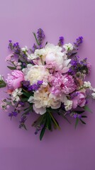 Fototapeta premium A close-up shot of a bouquet of purple and white peonies and lavender flowers on a lilac background