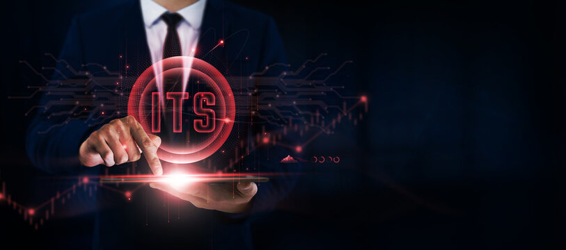 ITS Businessman Uses Tablet and Digital Networking Interface on Intelligent Transportation Systems Icon on Roadways, Smart Cities.