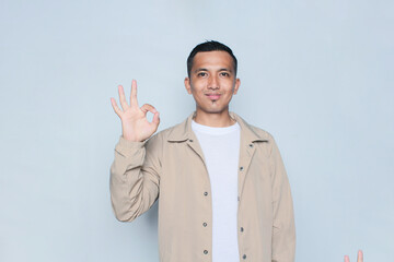 Asian young man smile and ok hand sign