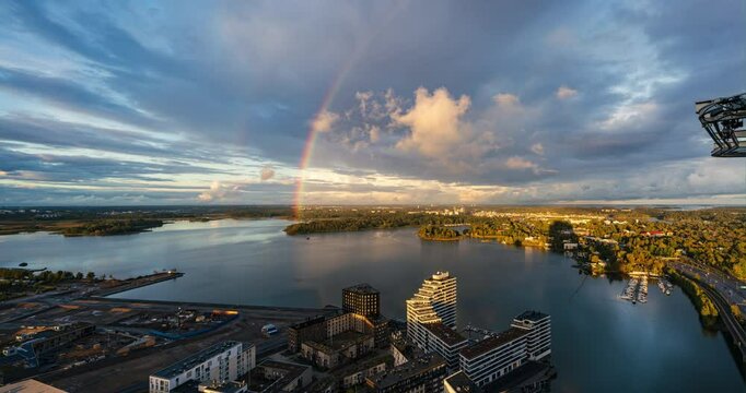 Time-lapse of a rainbow above the sea.', in front of the  Kulosaari, fall sunset in Helsinki