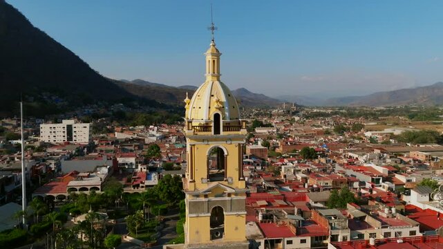 Tamazula de Gordiano, Jalisco, Mexico - Tamazula Church Framed by the Majestic Backdrop of Mountains  - Orbit Drone Shot