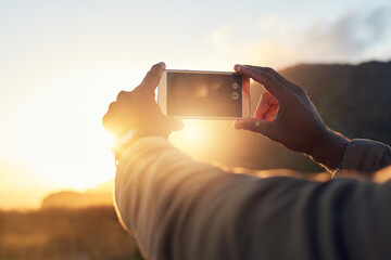 Sunset, phone and hand of person with picture for travel blog, update and memory of holiday. Sky,...