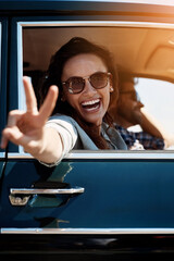 Road trip, happy woman and peace sign in car for travel, adventure and vacation journey to Mexico. Transport, vehicle and girl with hand gesture as reaction, driver and partner with sunglasses © NonVig/peopleimages.com