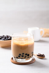 Iced coffee latte milk bubble tea in glass with white background, Asian drink