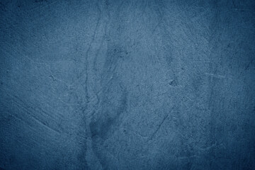 Grunge decorative navy blue dark stucco wall background.