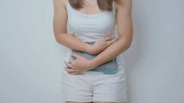 Menstruation period cycle of monthly and Stomachache concepts. woman having abdomen pain and menstrual ache with hot water bottle, illness female suffer from premenstrual ache and body Health problem