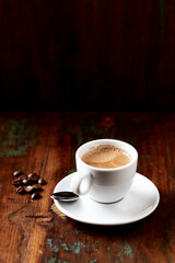 Cup of coffee on wooden background.
