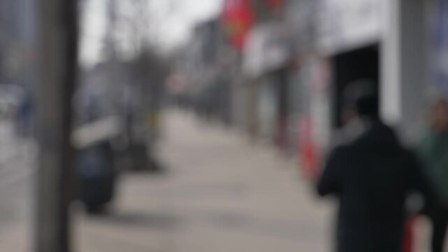 ppl walking in cloudy day at Danforth Village toronto