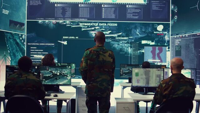 General headquarters under ruling of army IT professional that reviews insight about a new national safety mission. Command sergeant major briefing his marine corps troops with big data. Camera B.