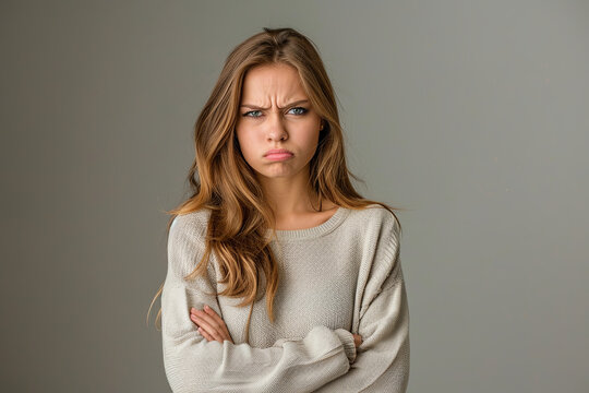 Sad, displeased, offended young woman expressing emotion