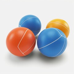 Four medicine balls of different colors sit on a white background