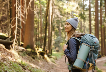 Woman hiking in the woods with backpack