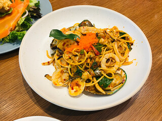 Stir fried spaghetti with tomyum seafood in Thailand.