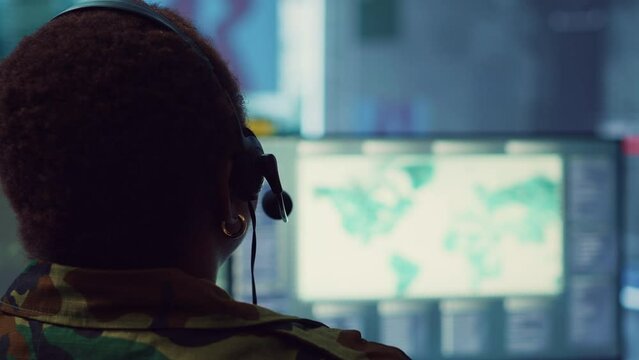 Woman military personnel tracking enemy vessels on the coast line territory, working on national safety and providing real time data to the dispatch center. Reconnaissance system. Camera A.