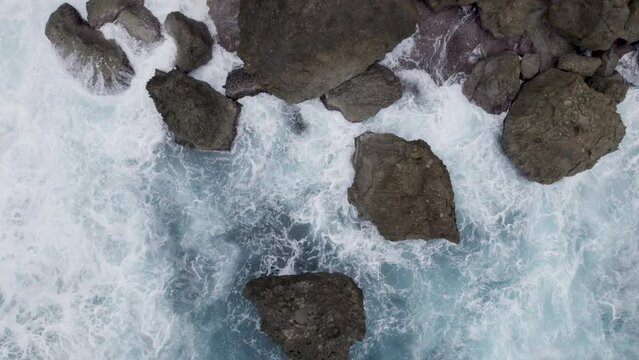 Aerial Rotating Shot Of Rugged Rocky Coastline And Waves - 