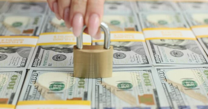 Padlock on a stack of dollar bills